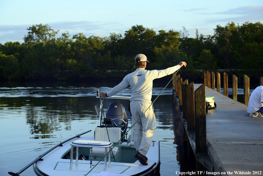 Flyfisherman on boat. 