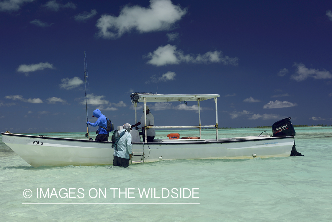 Flyfisherman with boat on flats.