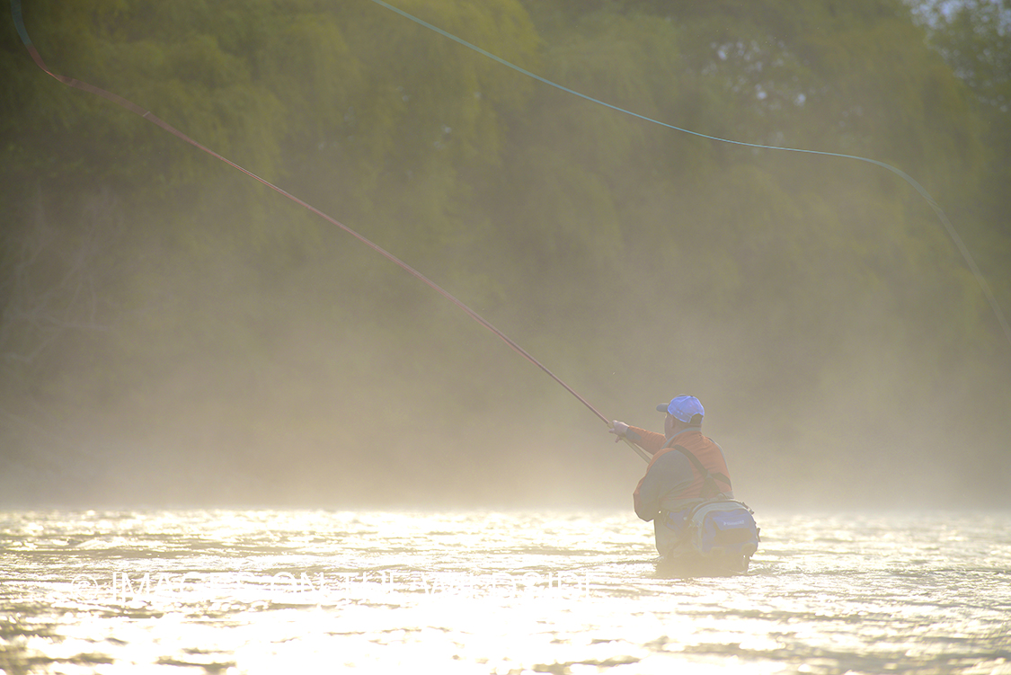 Flyfisherman casting on river in Chile.