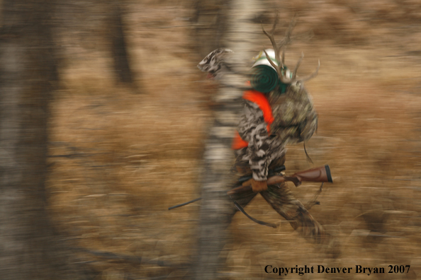 Mule deer hunter in field.