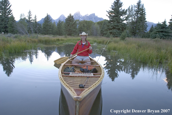 Woman in wooden canoe