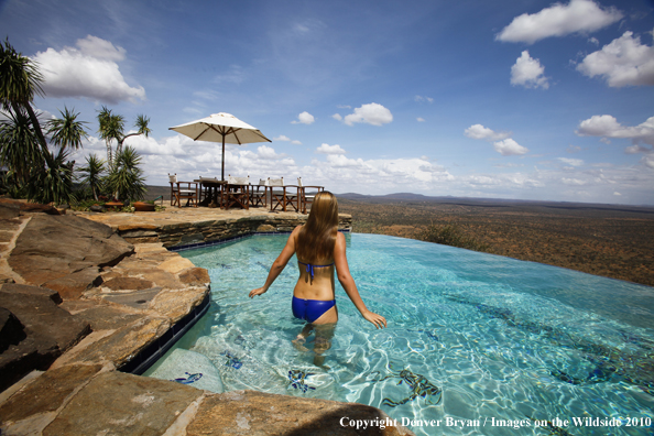 Woman by infinity pool