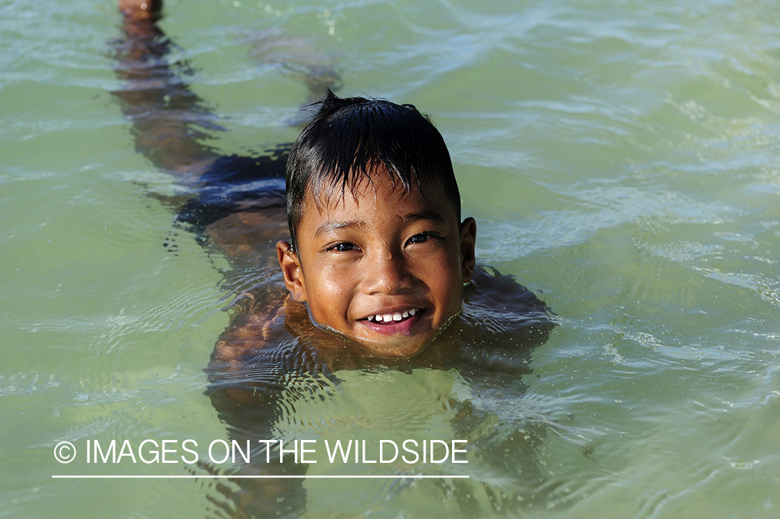 Native boy swimming on Christmas Island.