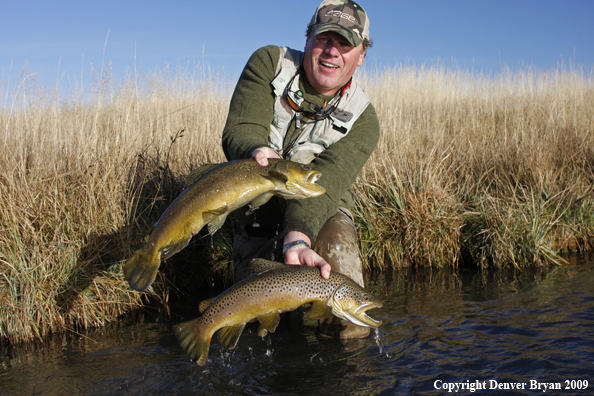 Flyfisherman with two large brown trout species.