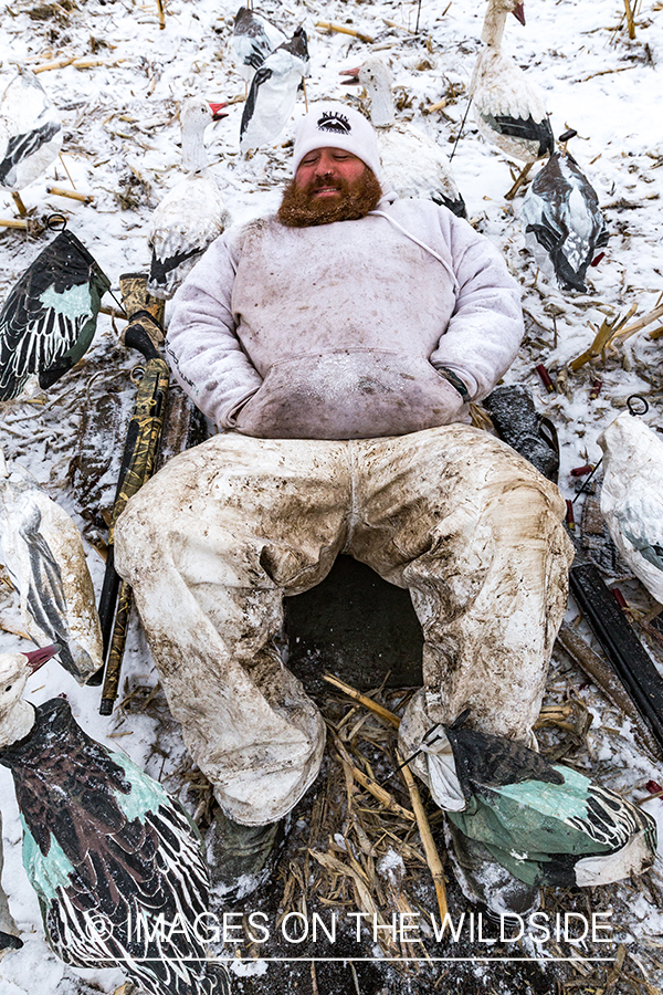 Hunters in field with decoys. 