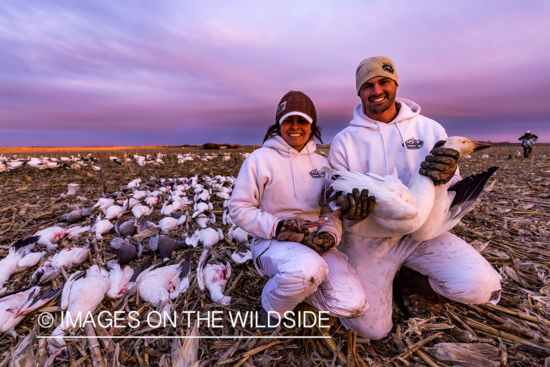 Hunters with bagged geese after successful day shooting.
