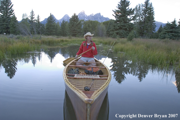 Woman in wooden canoe