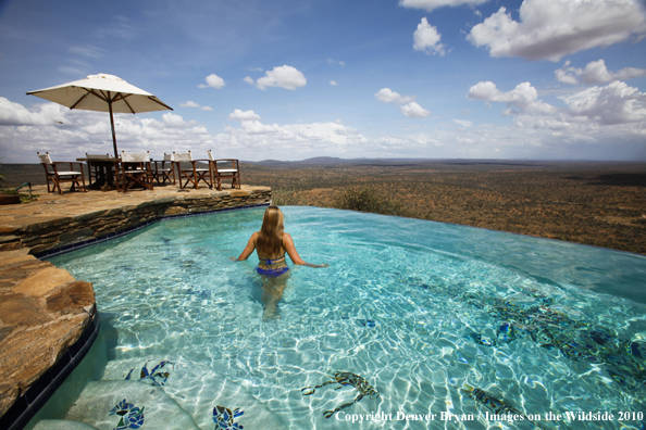 Woman by infinity pool