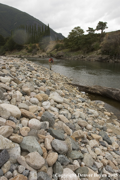 Flyfisherman casting on river.