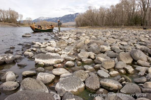 Flyfishermen preparing to launch wooden driftboat on Yellowstone River, MT.