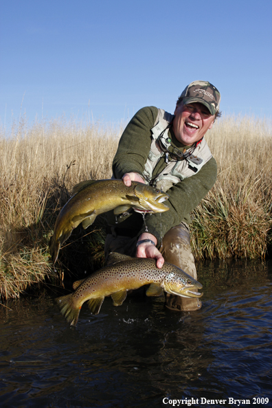 Flyfisherman with two large brown trout species.