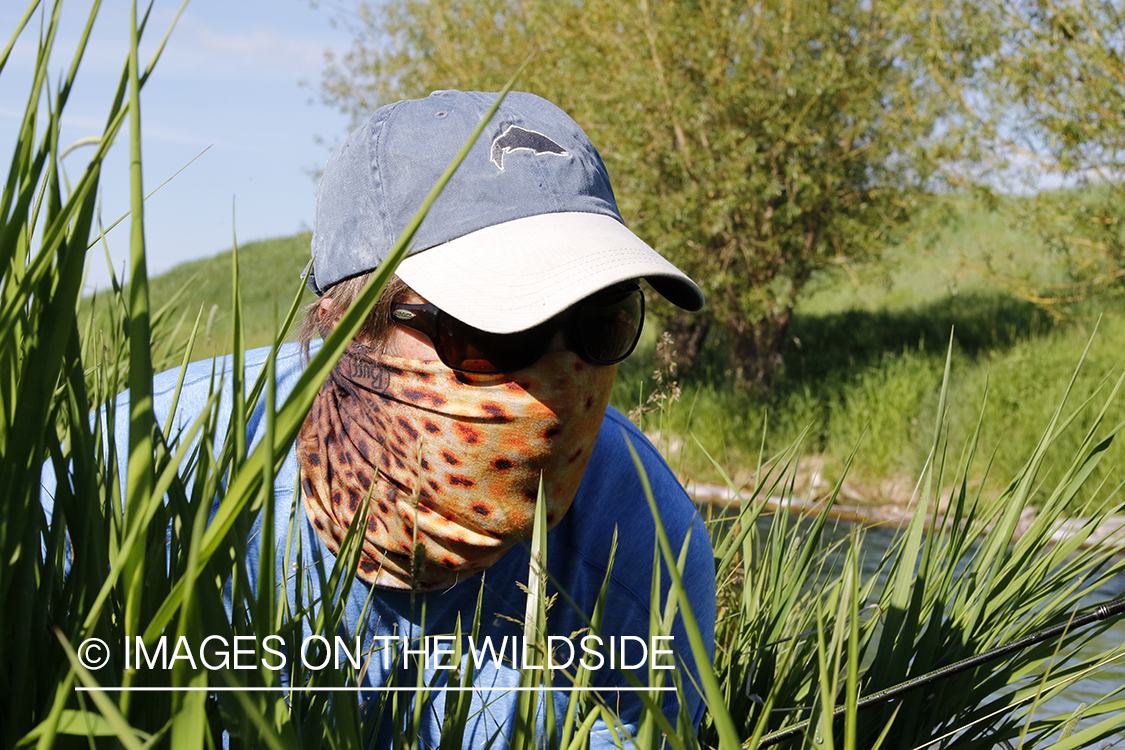 Flyfisherman with brown trout buff.