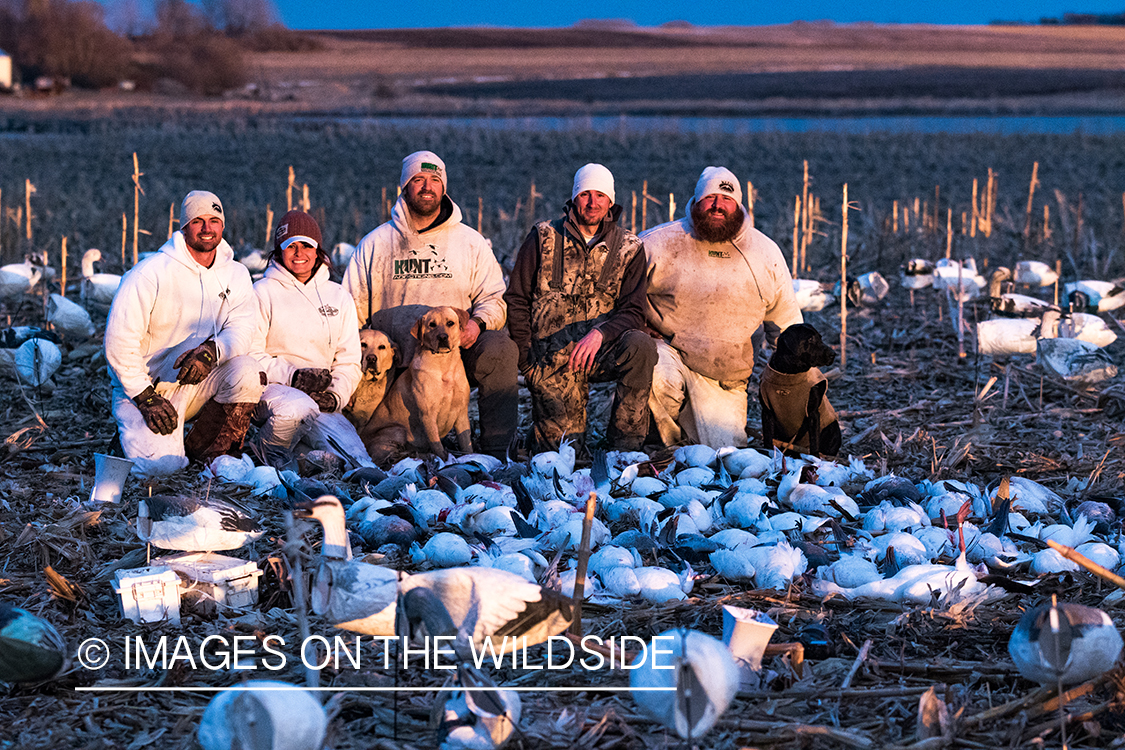 Hunters with bagged geese after successful day shooting.
