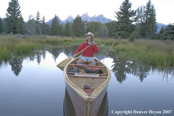 Woman in wooden canoe