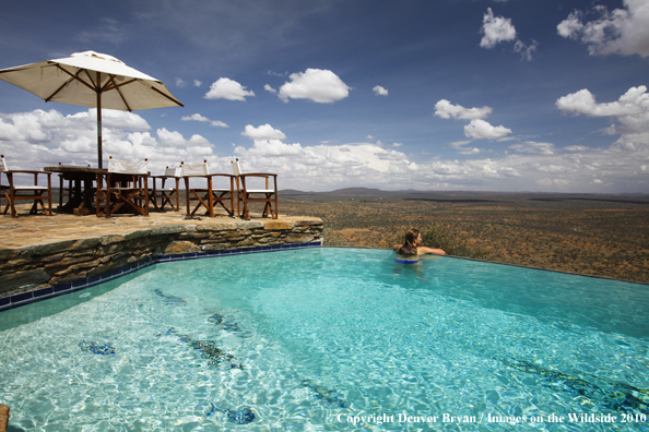 Woman by infinity pool