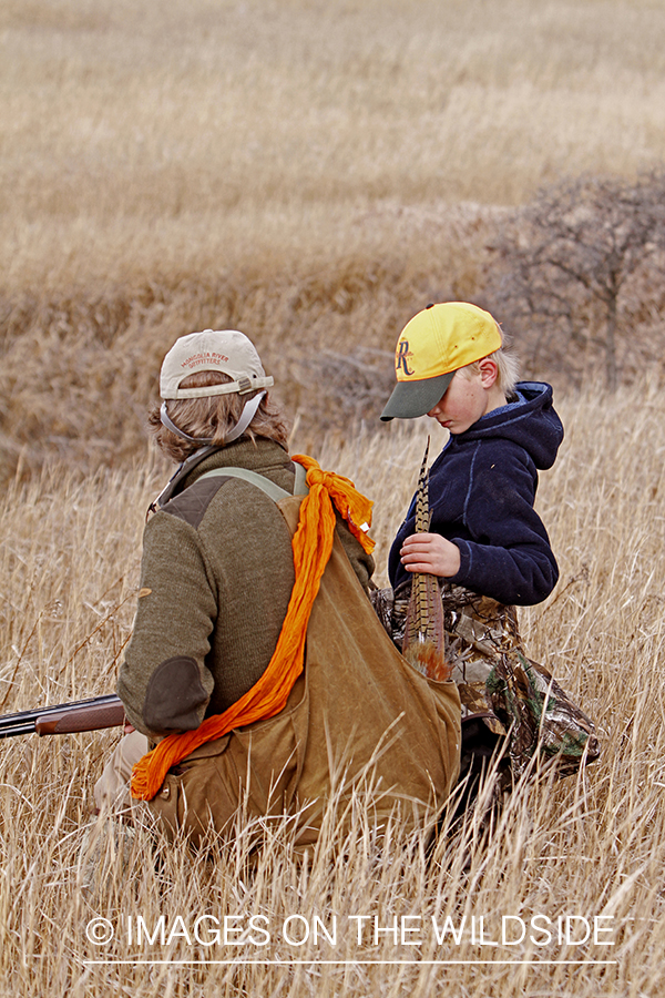 Father and son pheasant hunting. 