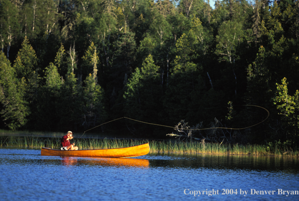 Flyfishermen fishing from canoe.