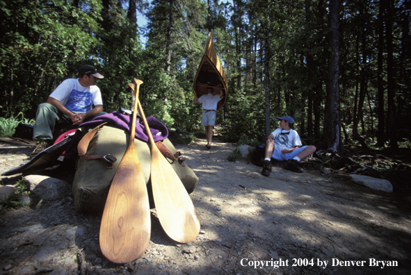 Father and son portaging cedar canoe.