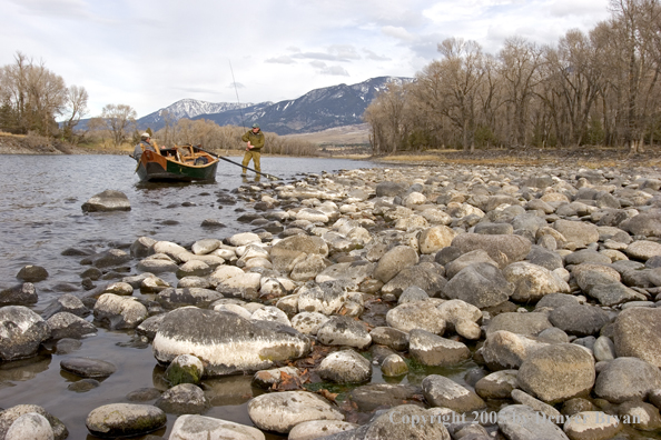 Flyfishermen preparing to launch wooden driftboat on Yellowstone River, MT.