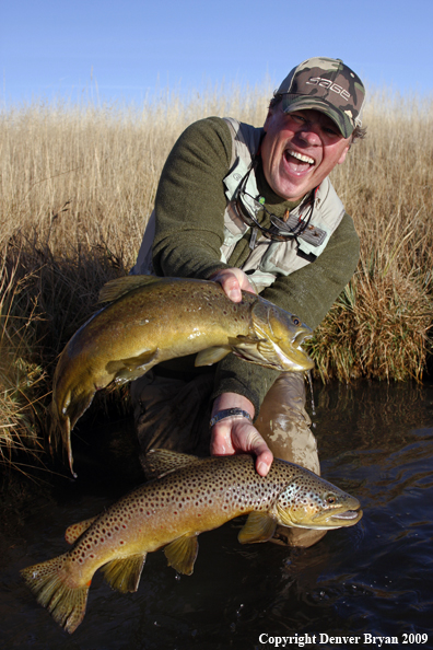 Flyfisherman with two large brown trout species.