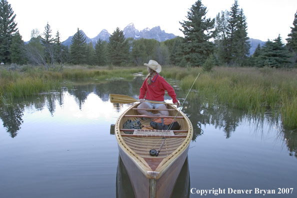 Woman in wooden canoe