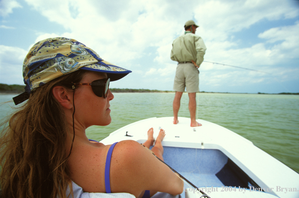 Saltwater flyfishing couple looking for fish.