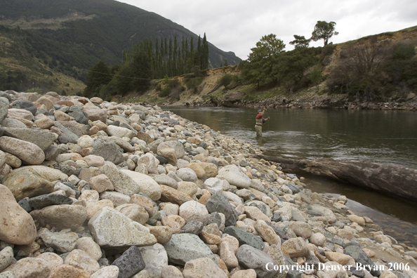 Flyfisherman casting on river.