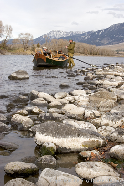 Flyfishermen preparing to launch wooden driftboat on Yellowstone River, MT.