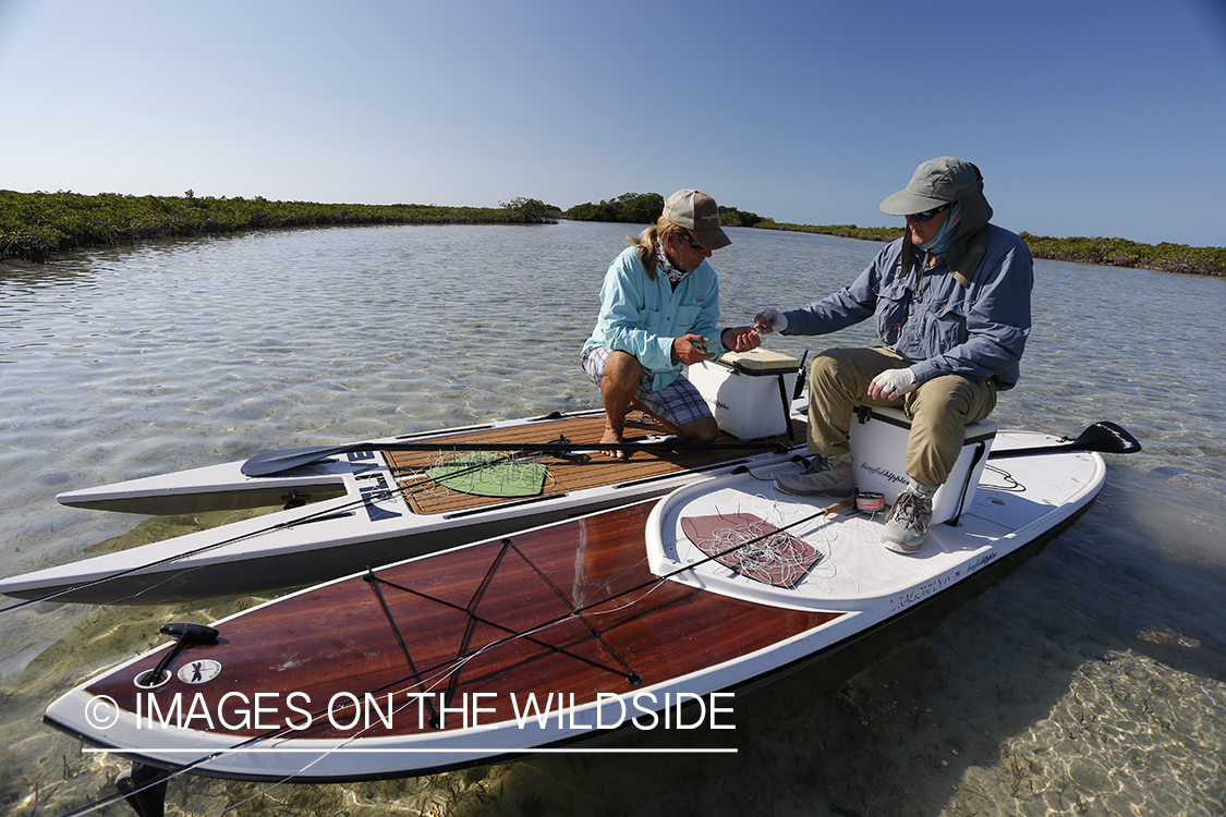 Saltwater flyfishermen on stand up paddle boards.