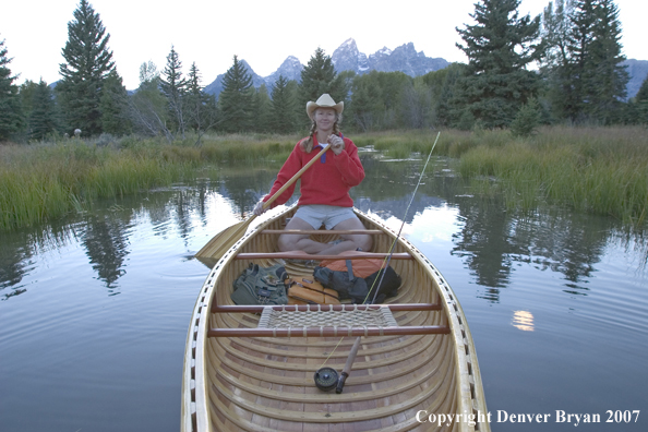 Woman in wooden canoe