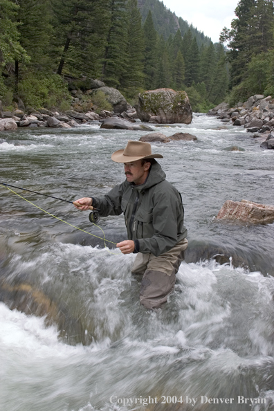 Flyfisherman pocket fishing on stream.