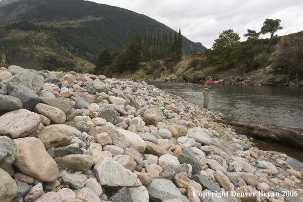 Flyfisherman casting on river.