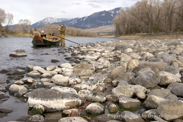 Flyfishermen preparing to launch wooden driftboat on Yellowstone River, MT.