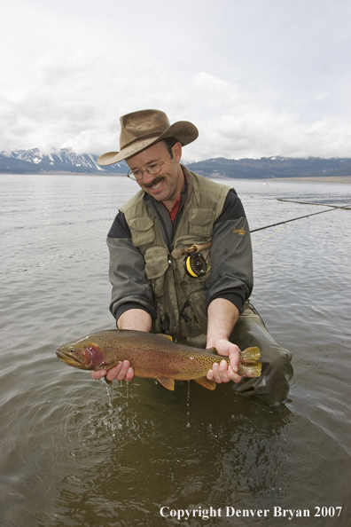 Flyfisherman with large cutthroat trout.