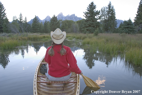 Woman in wooden canoe