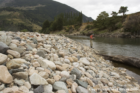 Flyfisherman choosing fly on river.