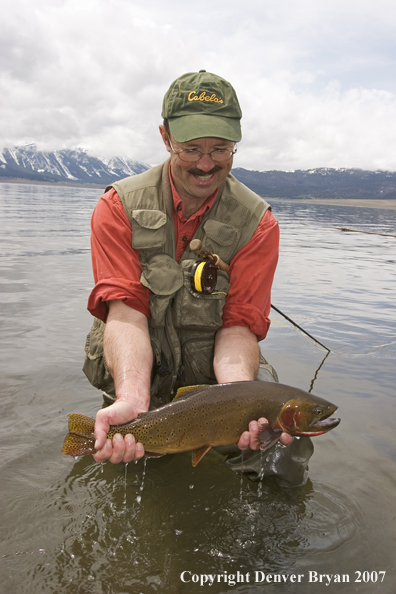 Flyfisherman with large cutthroat trout.