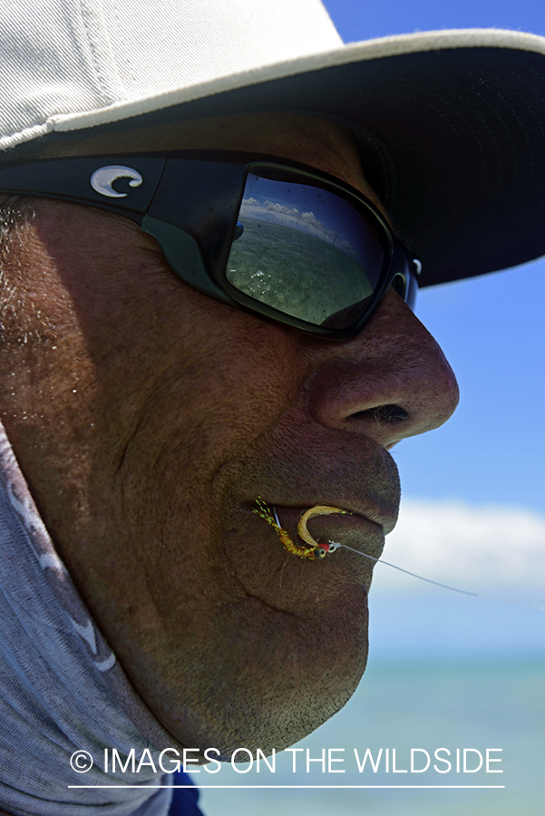 Flyfisherman with fly in mouth.