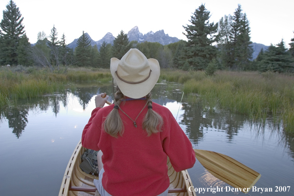 Woman in wooden canoe