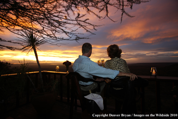 Couple watching sunset on safari