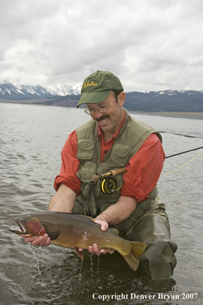 Flyfisherman with large cutthroat trout.