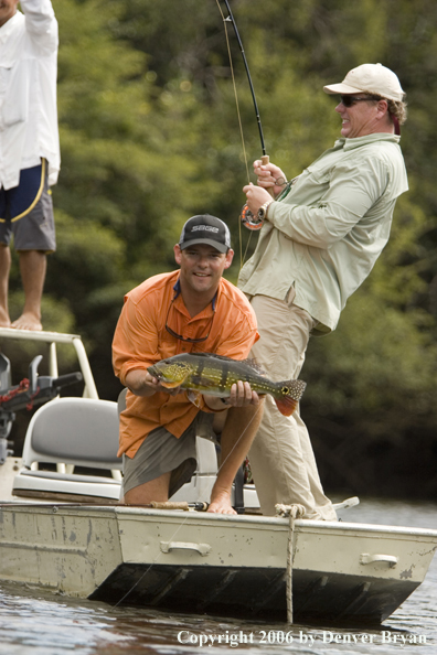 Fishermen holding Peacock Bass