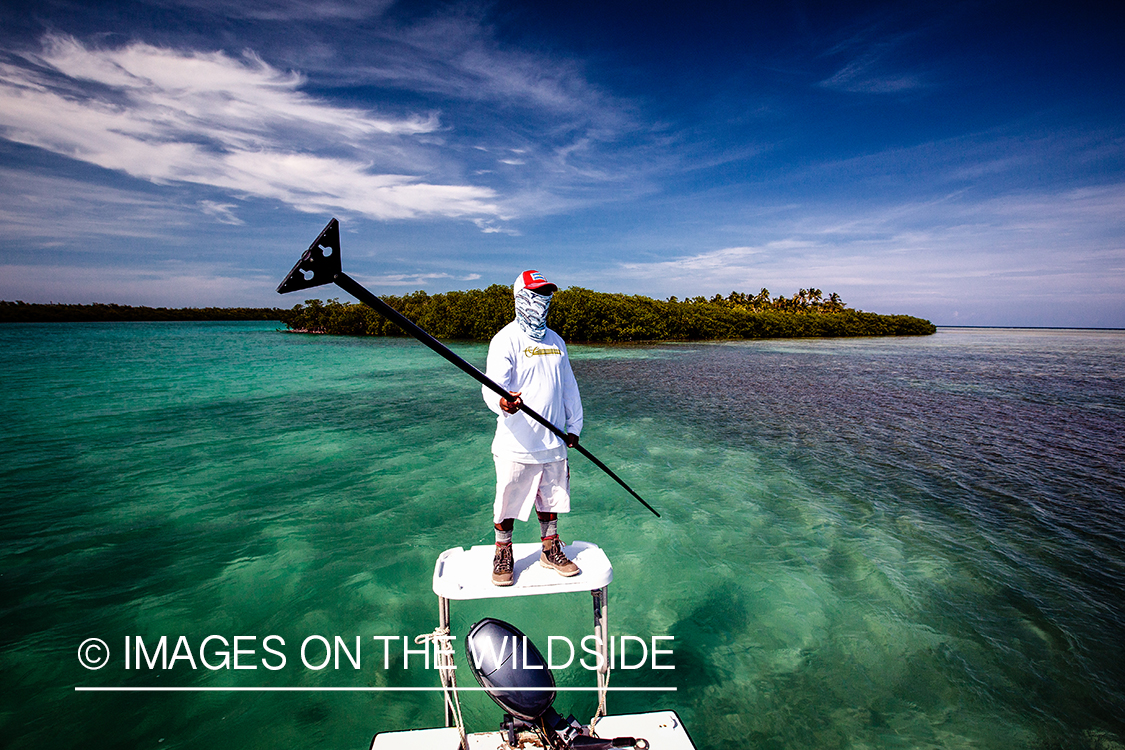 Flyfisherman with fishing guide on flats boat.