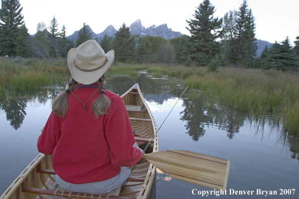 Woman in wooden canoe