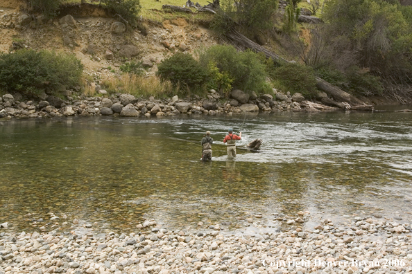 Flyfishermen casting on river.