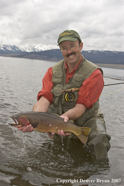 Flyfisherman with large cutthroat trout.