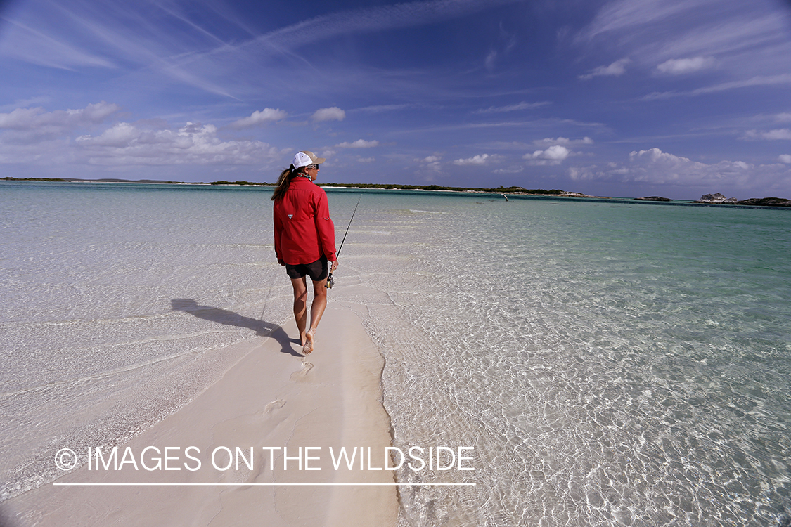 Saltwater flyfishing woman walking on flats.