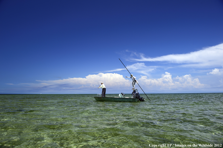 Flyfishermen on boat. 