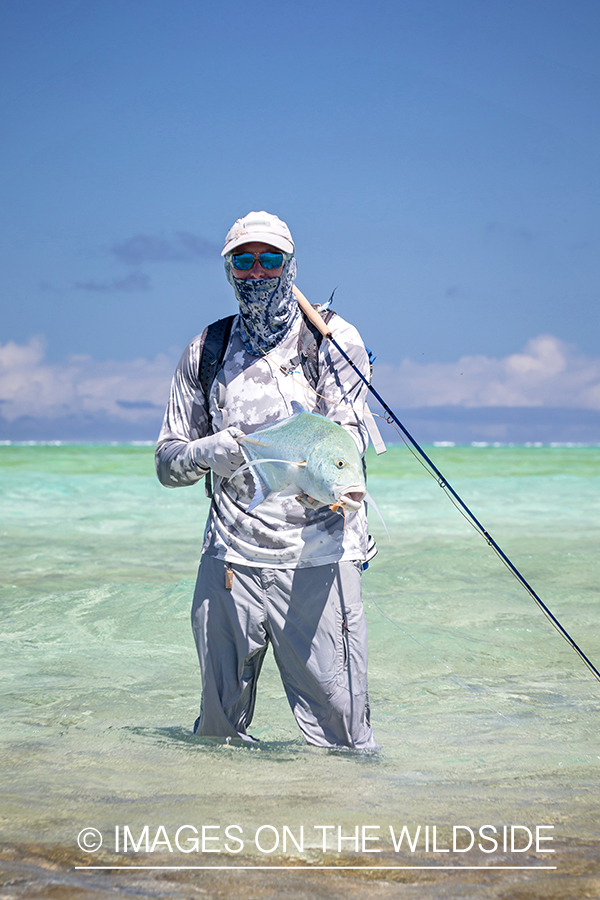 Flyfisherman with bluefin trevally.
