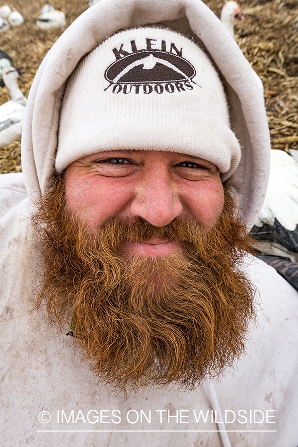 Hunters in field with decoys. 